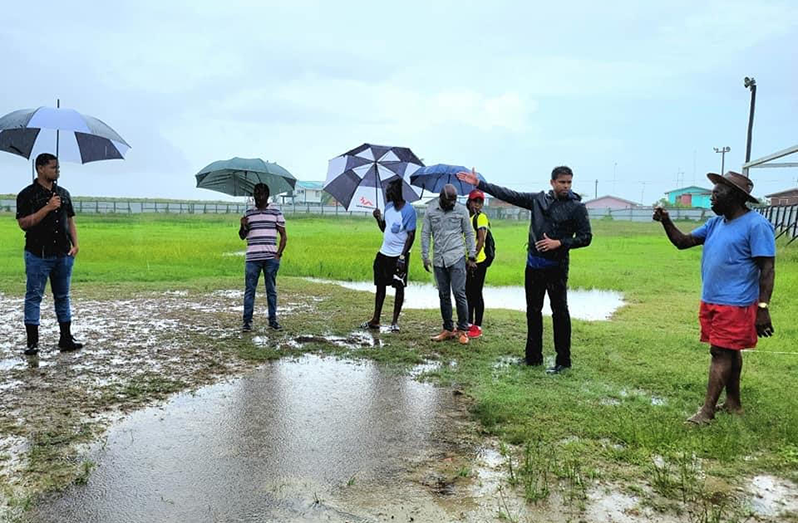 Minister of Culture, Youth and Sport, the Honourable Charles Ramson Jr. braving a torrential downpour while addressing residents of Den Amstel during his outreach in Region Three.