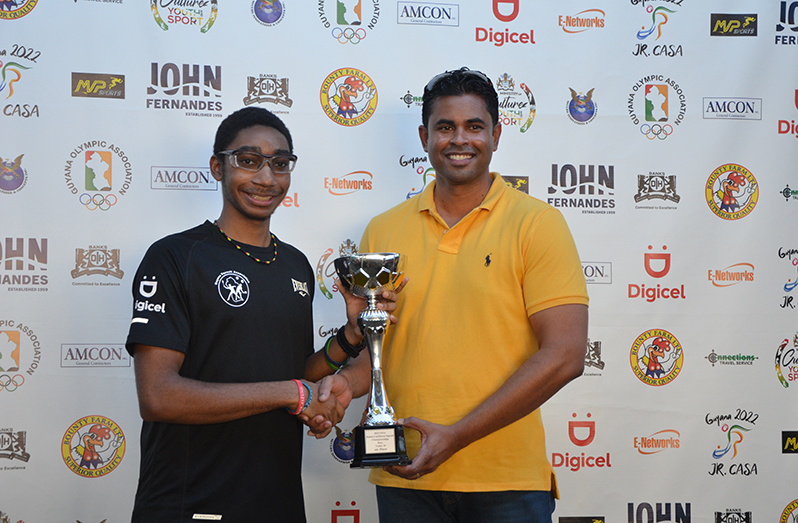 Caribbean Under-19 Champion, Shomari Wiltshire, collects his award from Minister of Sport, Charles Ramson Jr.
