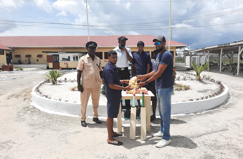 Siddiq Mohamed (right) hands over some of the cricket bats and balls on behalf of Keemo Paul