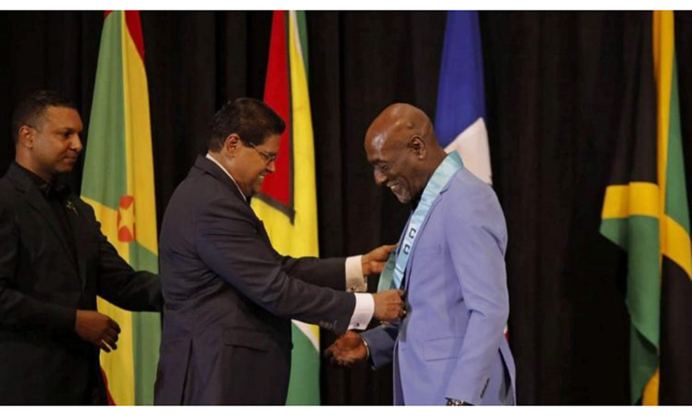 Former West Indies captain Sir Vivian Richards (right) receives the award from Chan Santokhi, President of the Republic of Suriname.