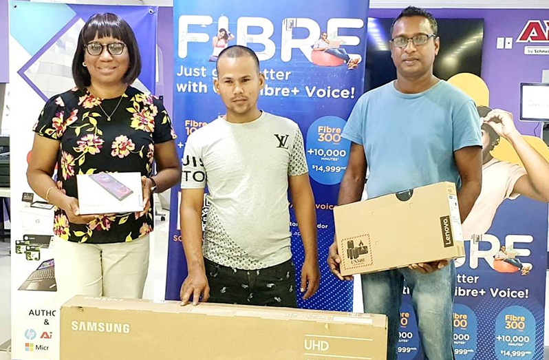 The winners from left: Jennifer Simon, Victor Low and Khemraj Sawh receive their prizes at STARR Computer, Brickdam Georgetown