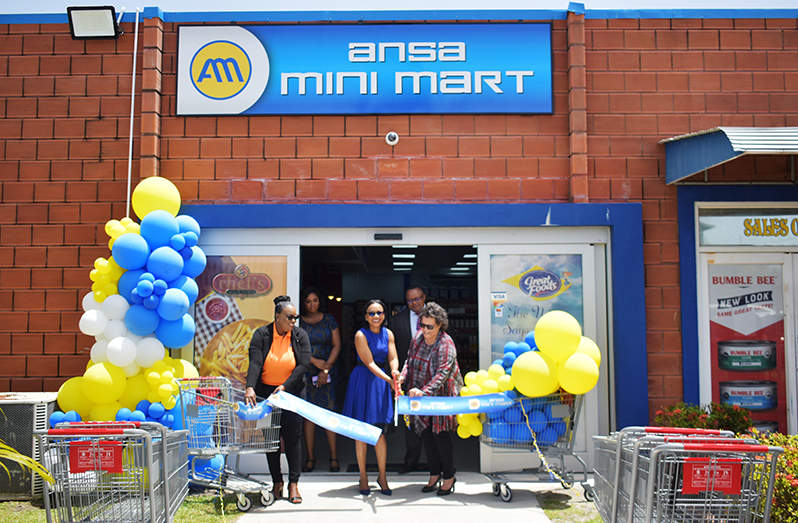 Tourism, Industry and Commerce, Minister Oneidge Walrond cutting the ceremonial ribbon to officially open the new mini mart (Cark Croker photo)