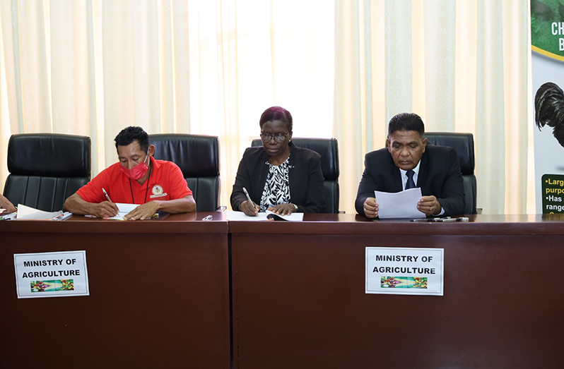 A Toshao from Region Nine with Permanent Secretary of the Agriculture Ministry, Delma Nedd, and Minister Mustapha at the brief signing ceremony on Wednesday (Ministry of Agriculture photo)