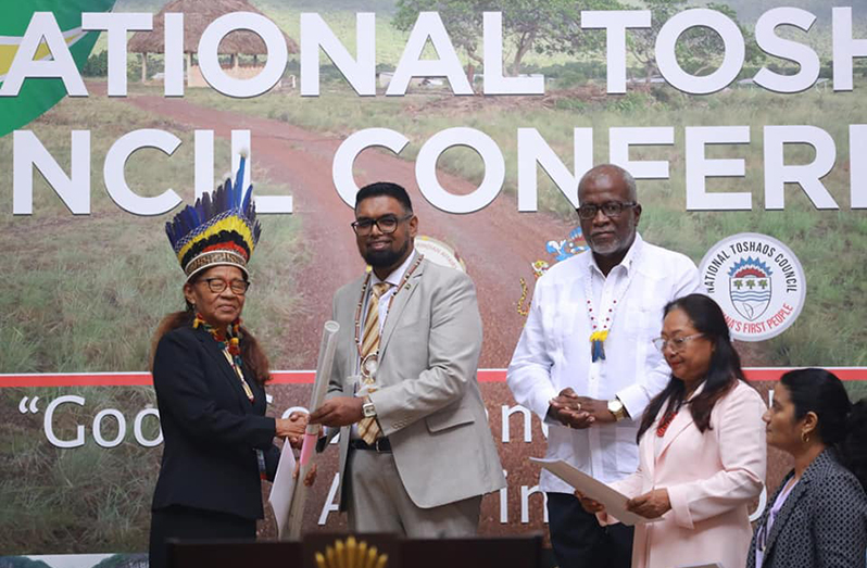 Mainstay/Whyaka’s Toshao Yvonne Pearson receives her village’s certificate of title from President Irfaan Ali. Also pictured are Prime Minister Mark Phillips and Minister of Amerindian Affairs, Pauline Sukhai (DPI Photos)