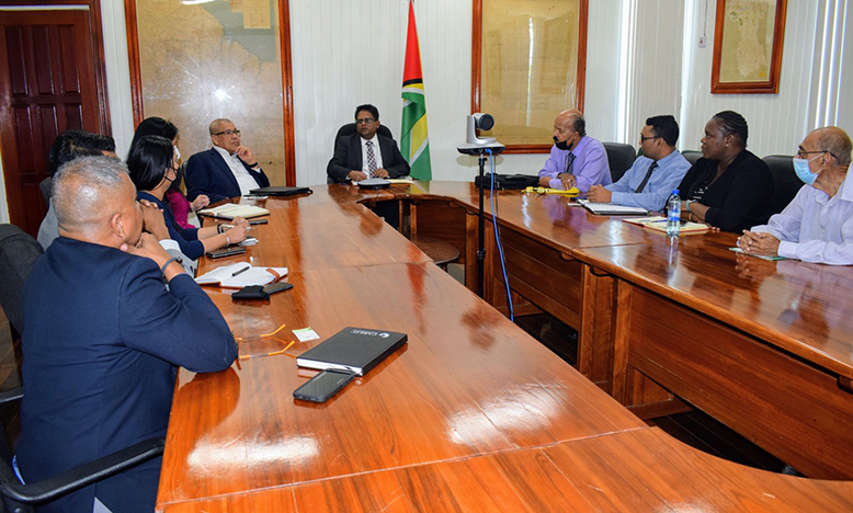 Senior Minister, Dr Ashni Singh, and GRA’s Commissioner-General Godfrey Statia engage recently appointed members of the Boards (Ministry of Finance photo)