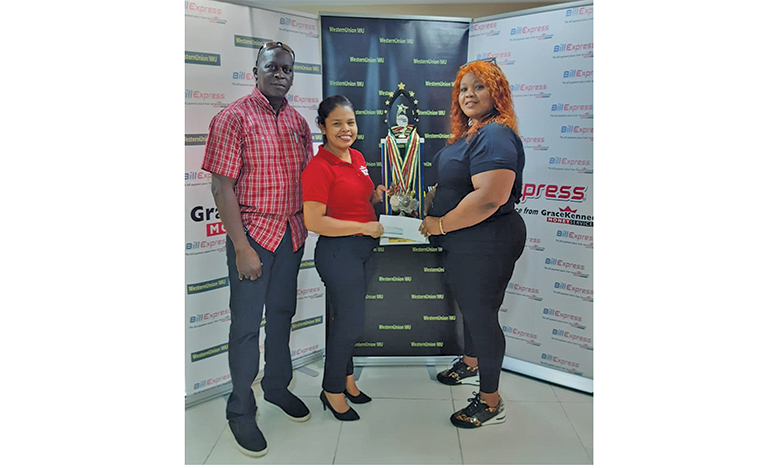 In photo, Marketing Assistant, Mrs Tina Seabra-Gibson, hands over the second-place trophy, medals and sponsorship to Charlyn Barnwell as organiser Roderick Harry looks on approvingly.