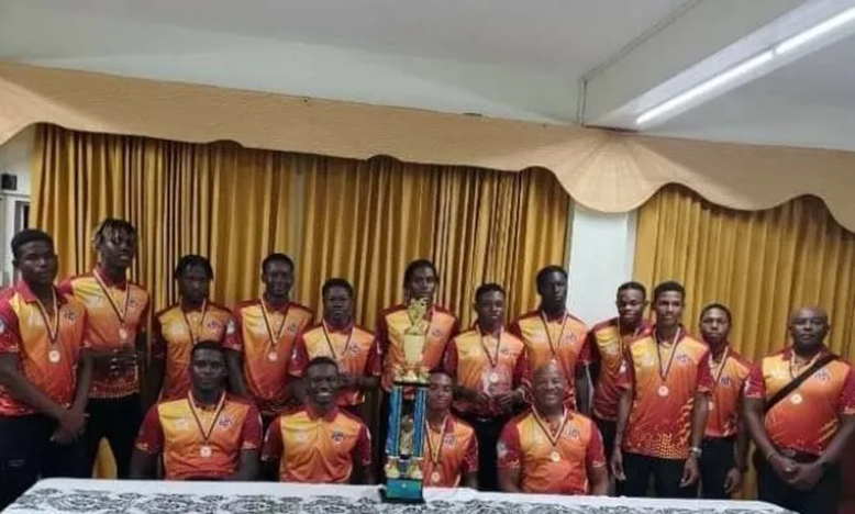 Leewards Under-19 cricketers celebrate with trophy after being crowned champions.