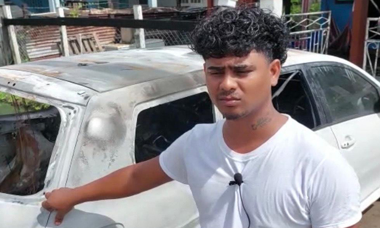 Chandrapaul Mohabir next to his torched car