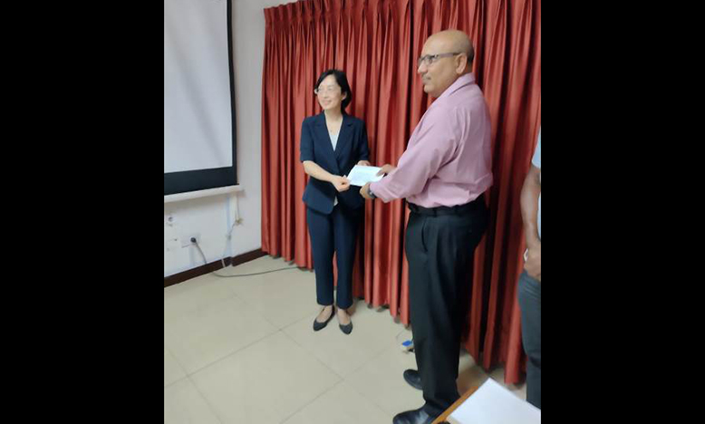 Chinese Ambassador to Guyana, Guo Haiyan, presenting the cheque to Civil Defence Commission (CDC) Director-General, Col. (ret’d) Nazrul Hussain