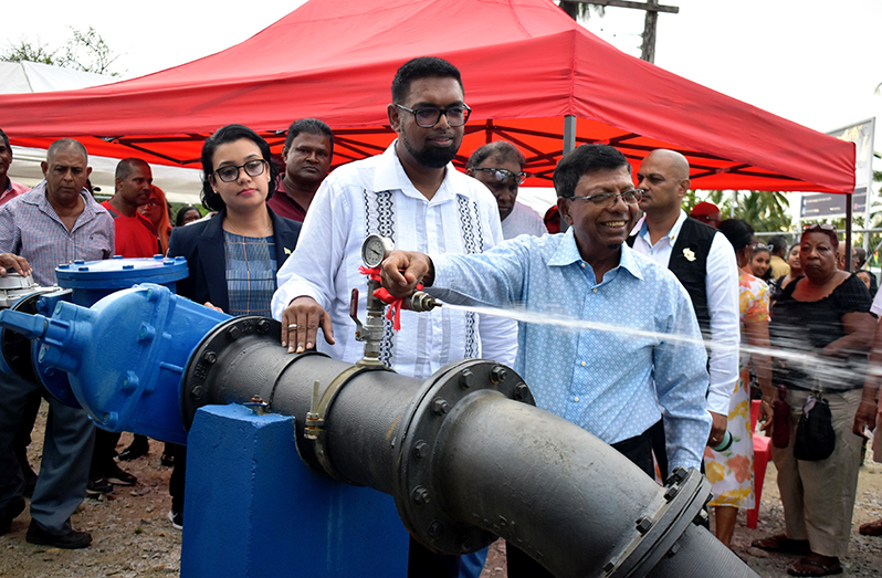 President, Dr. Irfaan Ali and GWI CEO, Shaik Baksh, test the
water pressure at the new well at Noitgedacht, Wakenaam
as Minister within the Ministry of Housing and Water, Susan
Rodrigues and others look on (Elvin Croker photo)