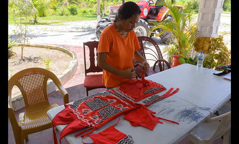 Sarah Fredericks putting together an outfit for heritage celebrations in the village