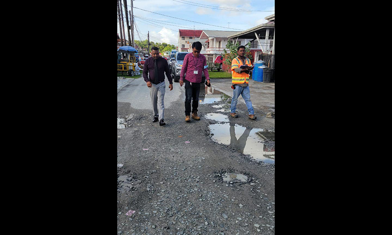 Minister within the Ministry of Public, Works Deodat Indar, engaging contractors during a recent inspection exercise in the Little Diamond/ Herstelling communities