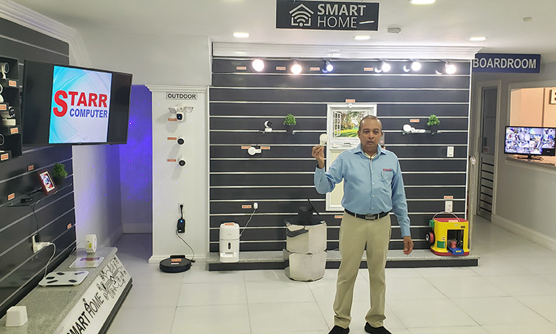 President of STARR Computer, Mike Mohan, demonstrates how a smart bulb could be controlled by a smart phone
