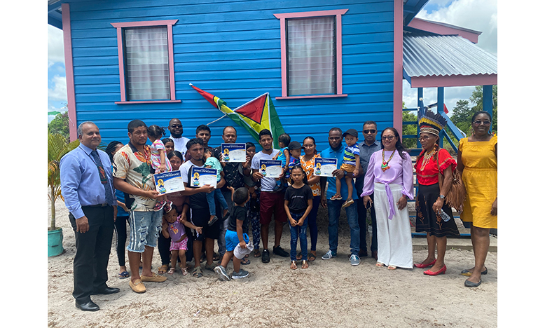 Members of the five families who received new homes. Also pictured are Minister of Amerindian Affairs Pauline Sukhai (third from right), Toshao of Mainstay/Whyaka, Yvonne Pearson-Fredericks (second from right), CEO of FFTP, Kent Vincent (left) and other officials