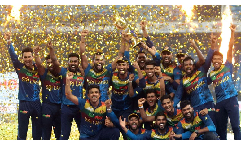 Sri Lankan players celebrate with the winners trophy after their win in the T20 cricket Asia Cup final match against Pakistan at Dubai International Stadium in Dubai on Sunday, September 11, 2022.(Photo:Raj Kumar/IANS)