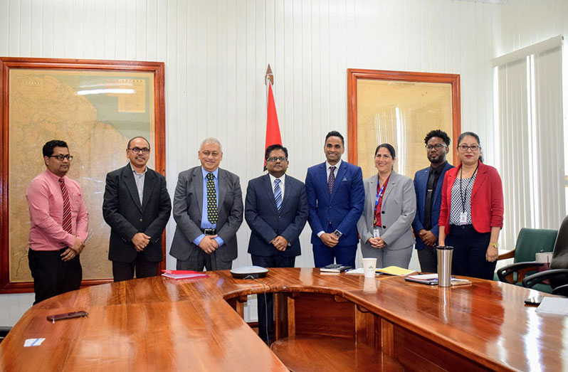 Senior Minister in the Office of the President with Responsibility for Finance, Dr. Ashni Singh (fourth left) with representatives of the IDB and Muneshwers Limited