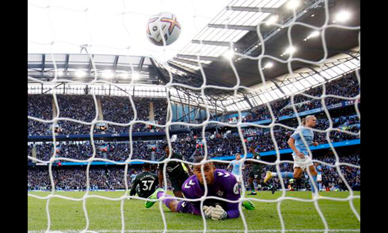 Manchester City's Erling Braut Haaland celebrates scoring their fourth goal yesterday as Southampton's Gavin Bazunu reacts