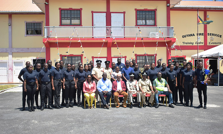 Home Affairs Minister Robeson Benn (seated second from left) with the 30 newly certified EMTs, along with Chief Fire officer, Gregory Wickham (seated third from right) and Permanent Secretary of the Ministry of Home Affairs, Mae Toussaint Jr Thomas (seated first from left) (Elvin Carl Croker photo)