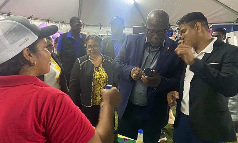 Prime Minister Mark Phillips examines a sauce at the ‘expo’