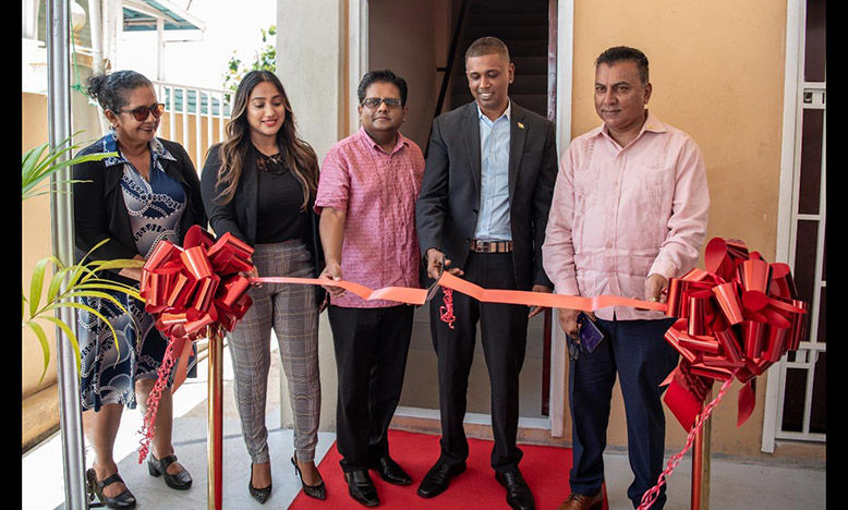 Senior Minister within the Office of the President with Responsibility for Finance, Dr. Ashni Singh and CEO of GO-Invest, Dr. Peter Ramsaroop assist Chief Executive Officer (CEO) of Express International Inc, Ken Deocharran in cutting the ceremonial ribbon as the CEO’s wife Cindy and Regional Chairman, Velma DaSilva look on