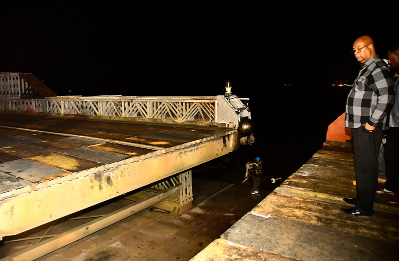 Minister of Public Works Juan Edghill looks on during the final moments as the retractor span of the bridge is closed (Adrian Narine photo)