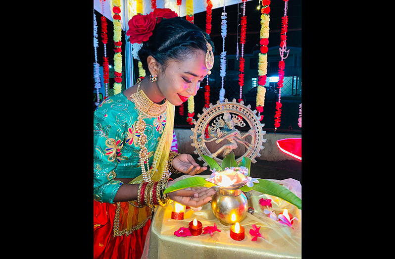 A dancer next to the diya that was lit up