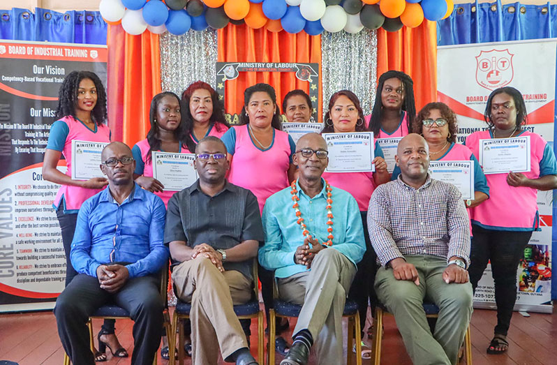 (Seated second from right)Minister of Labour, Joseph Hamilton; (seated third from right) BIT’s CEO, Richard Maughn and other officials flanked by the individuals certified in Garment Construction
