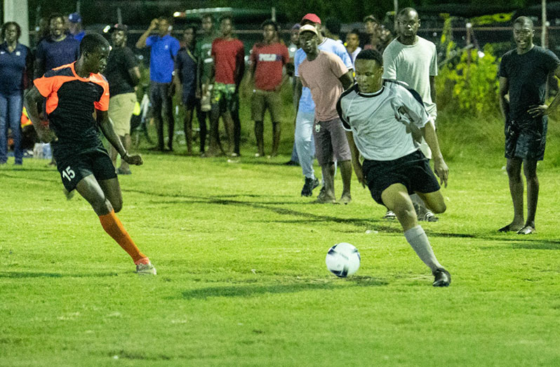 A BV/Buxton player trying to make his way around his East Ruimveldt opponent during their match at the Buxton Community Centre ground (Photo compliments: DPI)