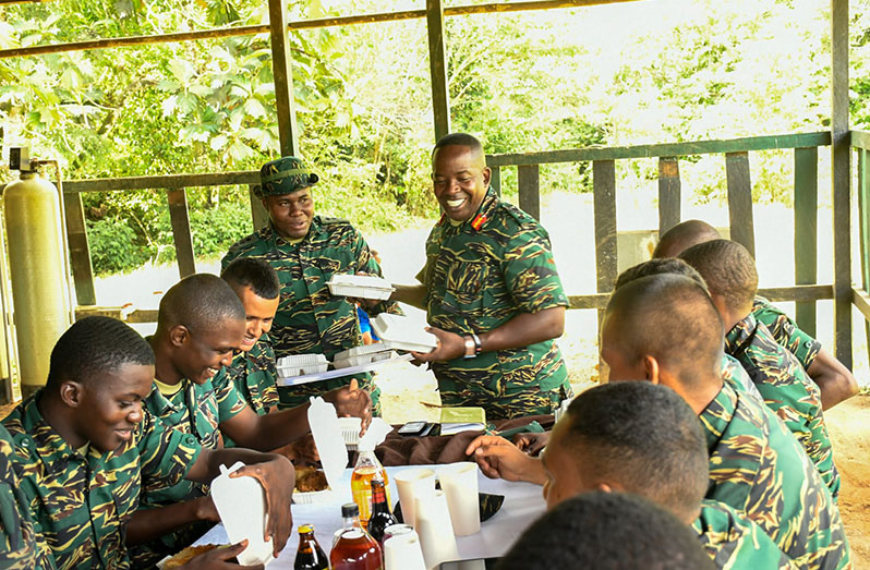 Chief-of-Staff Brigadier Godfrey Bess serves meals to soldiers at Base Camp Jaguar, New River (East Berbice-Corentyne)