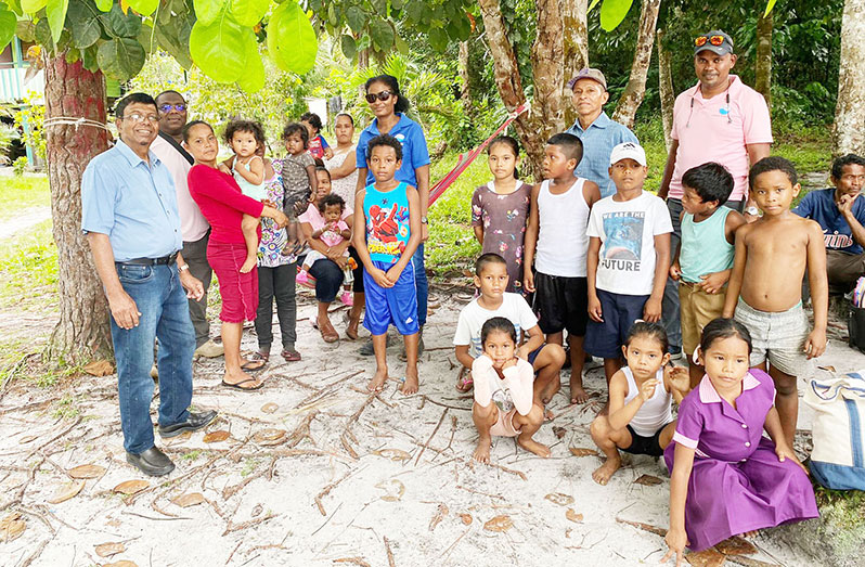 GWI CEO Shaik Baksh and the technical team with the children and other residents of Kairuni Village, on the Soesdyke-Linden  Highway