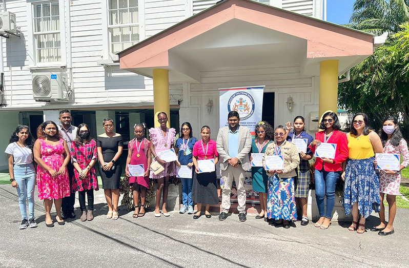 Girl coders with staff of the Industry and Innovation Unit outside the Prime Minister’s Office, Georgetown (OPM photo)