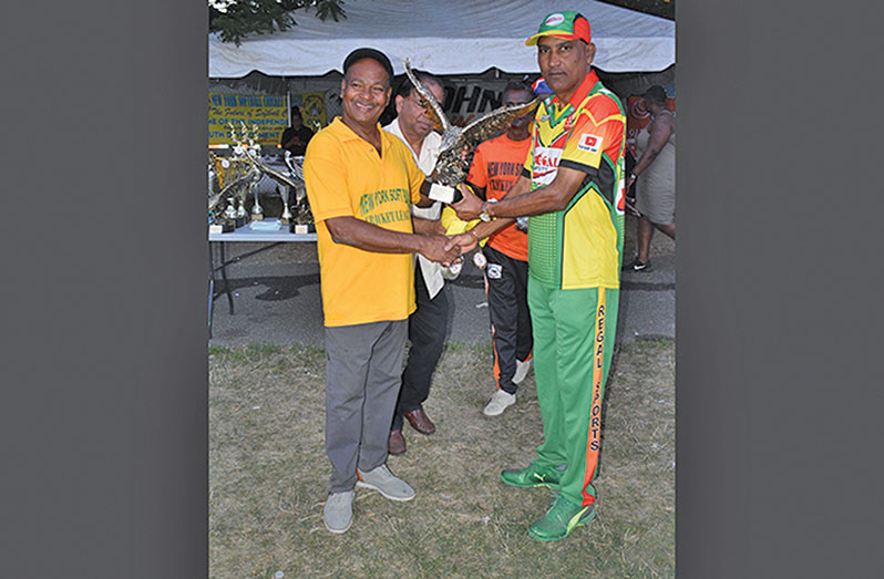 Regal Legends skipper Mahendra Hardyal (right) receives the Eagle from NYSCL president Eric Ferrier after his team’s triumph in the 2022 Independence Cup.