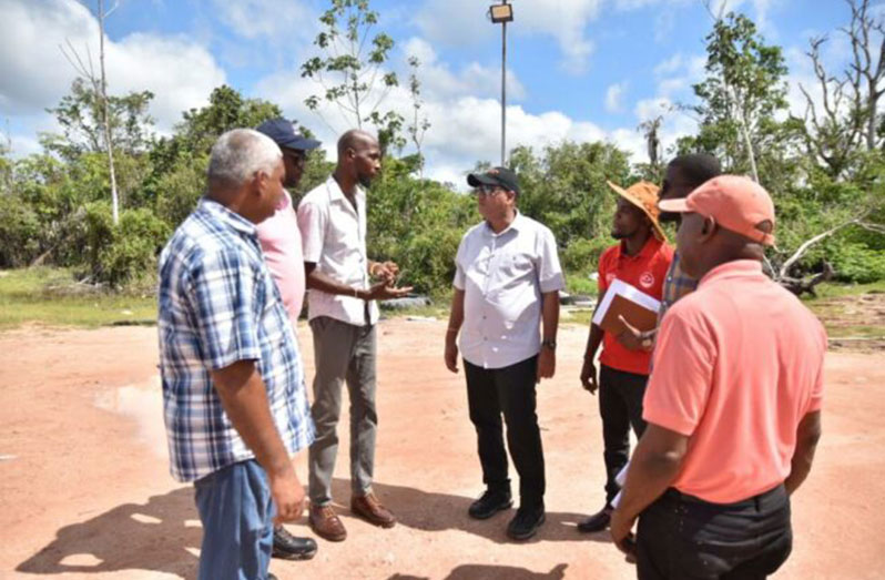 Minister of Housing and Water Collin Croal engaging residents as he enters Kwakwani