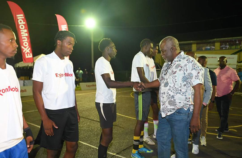 The Prime Minister greets the players before the start of the New Era Entertainment and ExxonMobil Futsal Tournament.