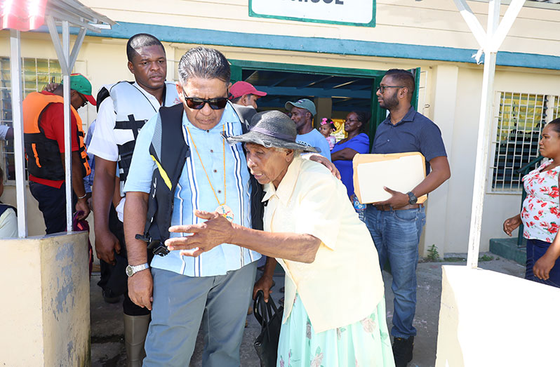 Minister Zulfikar Mustapha engages a senior citizen from Hackney (Ministry of Agriculture photos)