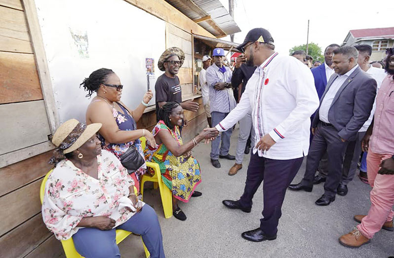 President Dr. Irfaan Ali engages a group of women during his recent community outreach to Den Amstel, Region Three (Essequibo Islands-West Demerara) (Office of the President photo)
