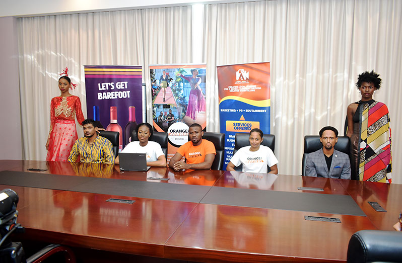 Sitting from left to right: Randy Madray, Jamicia McCalman-Nelson, Sidney Nelson, a model and Isahiah Luther. Also pictured are two models wearing local designs (Carl Croker photo)