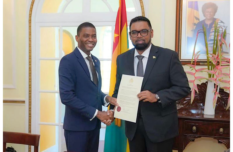 President, Dr. Irfaan Ali handing over the document of ascension to the Chair of the Ministerial Council of the RSS, Prime Minister of Grenada, Dickon Mitchell (Office of the President photo)