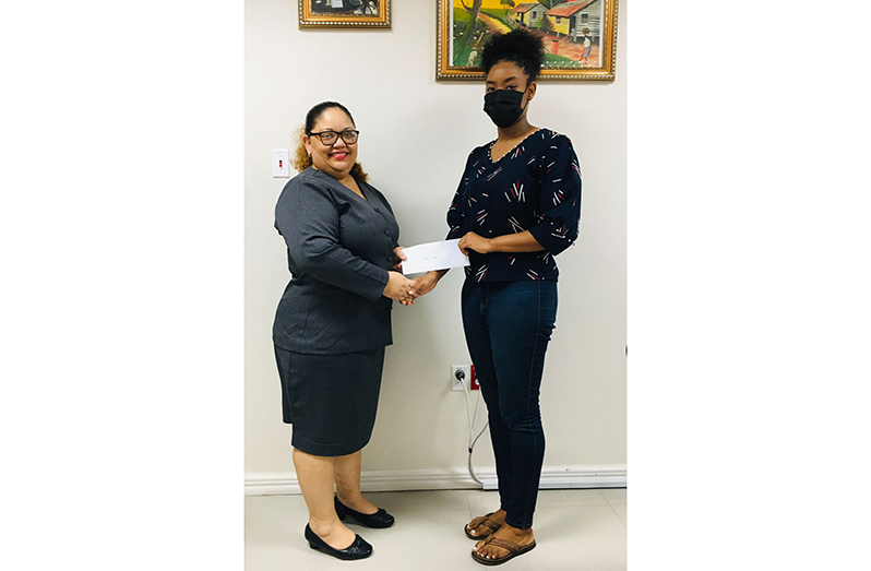 Future Chemical Engineer, Alizia Ash, received her sponsorship cheque for $2M from Gafoors Administrative Manager, Dione Foo, to further her studies