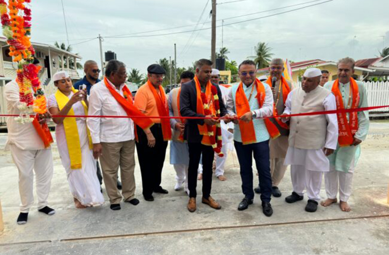 Minister within the Public Works Ministry Deodat Indar cutting the ceremonial ribbon to commission the school alongside Indian High Commissioner to Guyana, Dr. K J Srinivasa