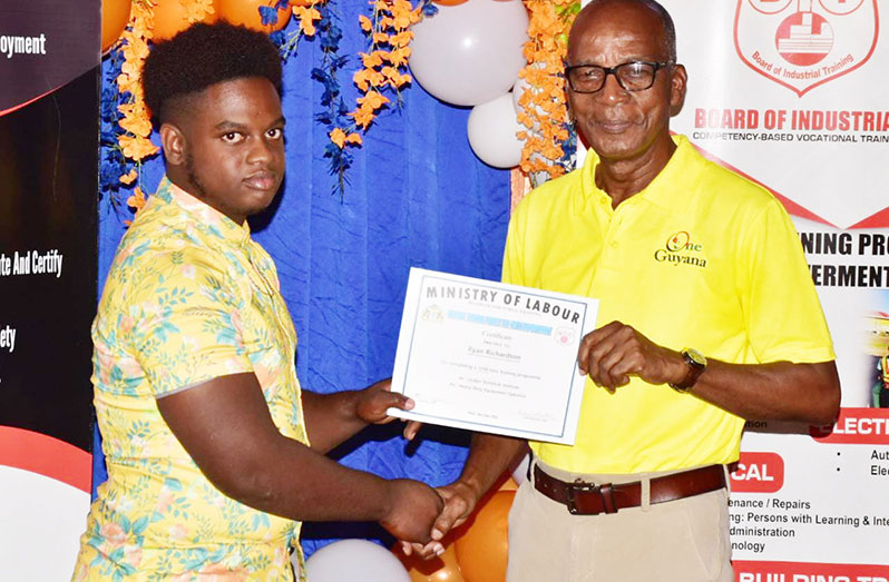 A graduate receiving his certificate from Minister of Labour, Joseph Hamilton