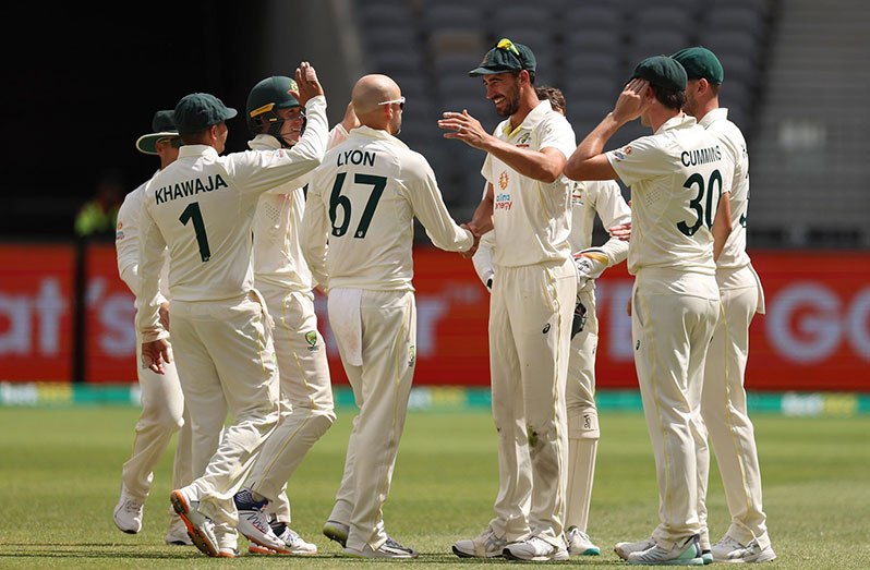 Nathan Lyon is mobbed by his team-mates after striking early on the final day  •  (AFP/Getty Images)