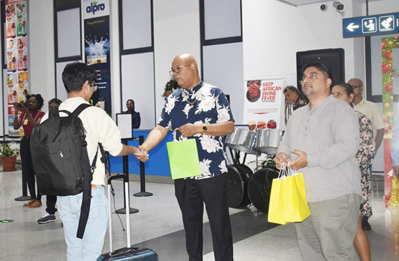 Minister of Public Works, Juan Edghill and Chairman of CJIA's Board of Directors, Sanjeev Datadin distributing gifts at CJIA to arriving passengers on Christmas Day (CJIA photo)