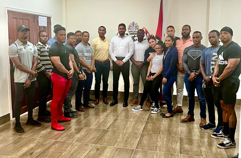Guyana Bodybuilding and Fitness Federation athletes and executives stand with Minister of Sport Charles Ramson