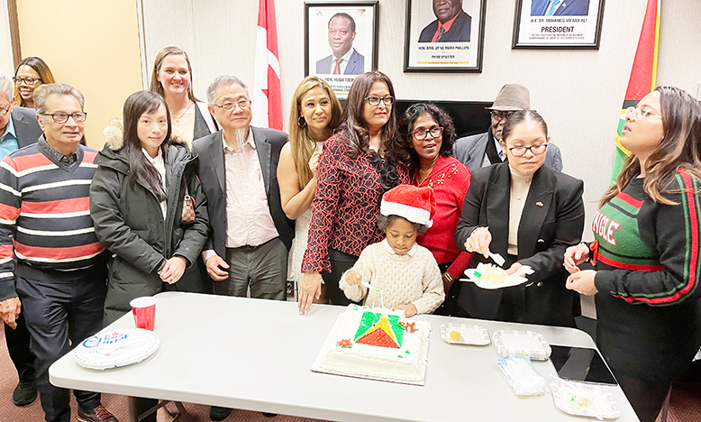 The symbolic cutting of a cake decked in the colours of the Guyana flag, to mark the occasion. Consul General (ag) Grace Joseph is second from right and on her left is Executive Secretary Nutana Singh