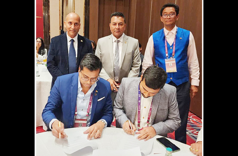 Dr. Rosh Khan and Squadron’s Rajan Singh sign the MoU. Standing from left are: Rafeek Khan, President of the Guyana Manufacturing and Services Association (GMSA); Dr. Peter Ramsaroop, Chief Executive Officer (CEO) of GO-Invest, and Paul Cheong, Chairman of the Private Sector Commission (Photo courtesy of ACE Professional Services & Business Development Consultancy)