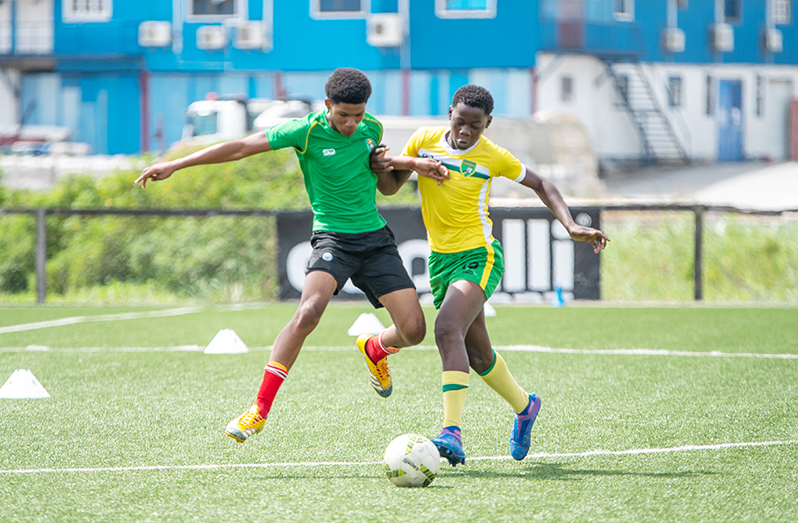 : Intense action between Georgetown (left) and East Coast that battled to a 1-1 draw yesterday (Delano Williams photos)