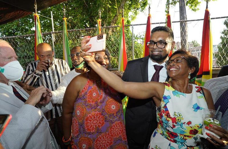 President, Dr Irfaan Ali poses for a ‘selfie’ with an attendee at the diaspora engagement event last July (Office of the President photo)