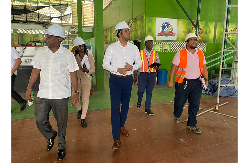 Minister Ramson (third from right), DoS Ninvalle (left) ADoS Dow-Richardson (second from left) and Sherwin Moore (second from right) inspect the interior of the Sports Hall.