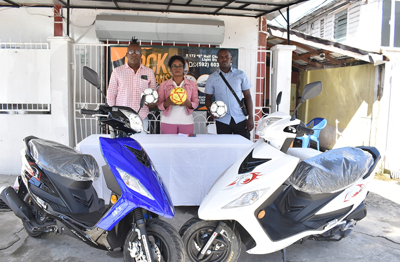 Fom left, Referees Co-ordinator Wayne Griffith; Rocks Auto and Trans General Manager, Yolandia Ross; and Selwyn Williams of Back Circle Football Club. (Clifton Ross photo)